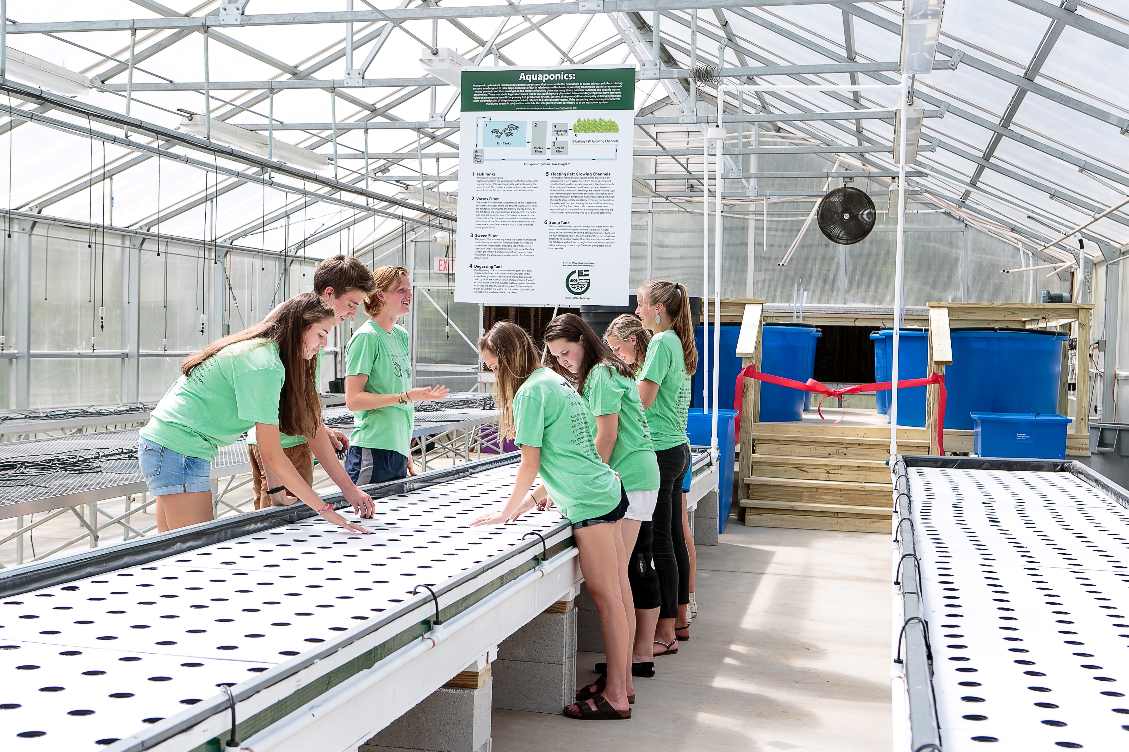 Mustang Project students putting the final touched on the aquaponics system before the ribbon cutting. (Photo Credit: Drea Photo Artistry)