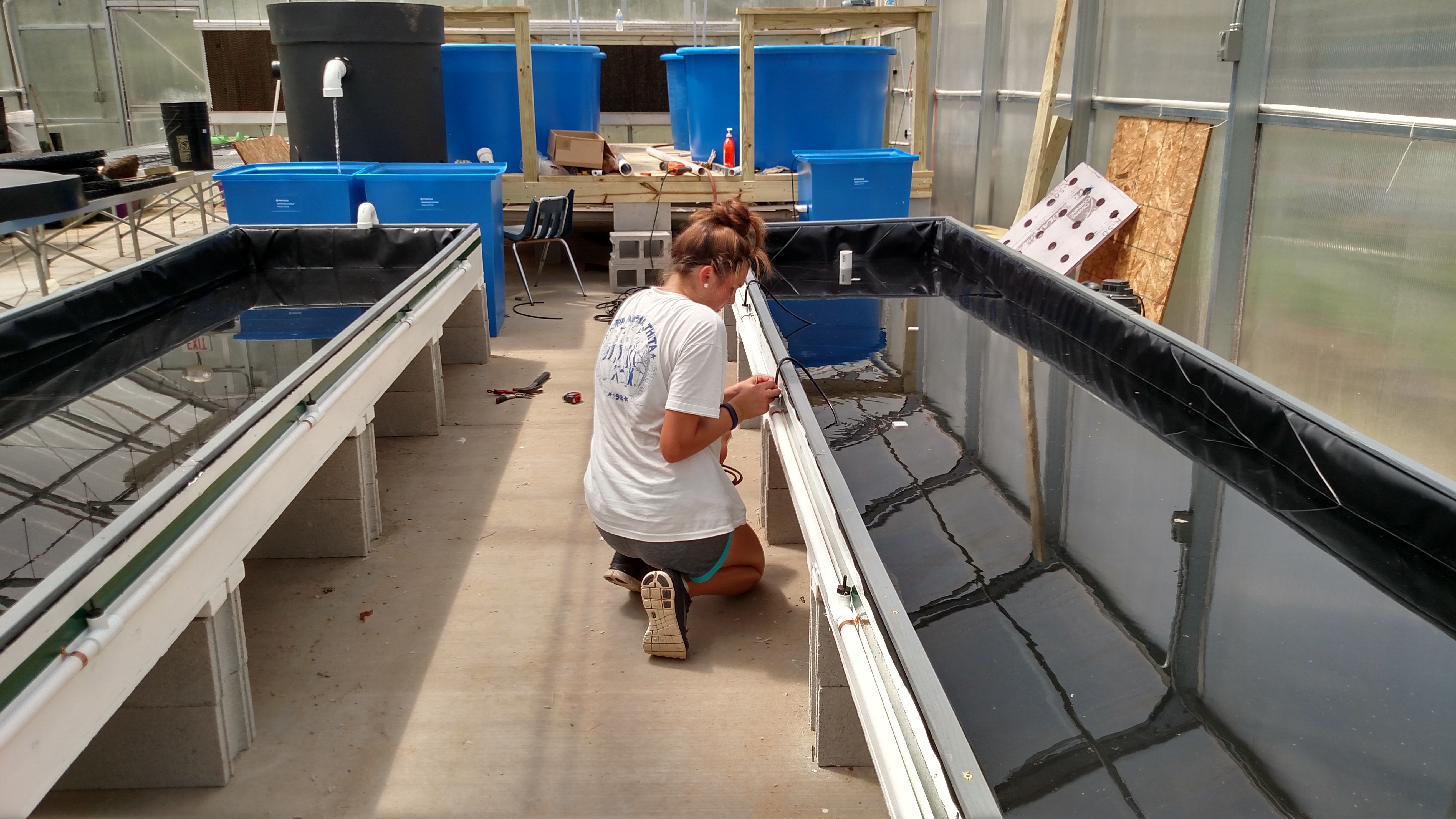 Midway through construction of the aquaponics system (Photo Credit: 100 Gardens)